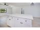 A kitchen island featuring white cabinetry and a countertop, set in a room with hardwood floors and modern design at 359 Salisbury St, Port Charlotte, FL 33954