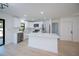 Spacious kitchen island with white cabinets and countertop, set in a bright room with modern features and wood floors at 359 Salisbury St, Port Charlotte, FL 33954