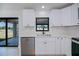 Modern kitchen showcasing white cabinetry, a stainless steel dishwasher, and an undermount sink with modern fixtures at 359 Salisbury St, Port Charlotte, FL 33954