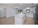Bright kitchen features new appliances, an island with breakfast bar, and a modern lighting fixture at 359 Salisbury St, Port Charlotte, FL 33954