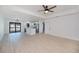 Bright living room with hardwood floors, modern ceiling fan, and an open layout that flows into the kitchen area at 359 Salisbury St, Port Charlotte, FL 33954