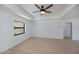 The spacious main bedroom features a ceiling fan, tray ceiling and a large window with natural light at 359 Salisbury St, Port Charlotte, FL 33954