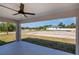 Covered patio area with a ceiling fan, offering a relaxing outdoor space with a clear view of the surrounding landscape at 359 Salisbury St, Port Charlotte, FL 33954