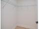 A simple walk-in closet with built-in shelving to maximize space at 359 Salisbury St, Port Charlotte, FL 33954