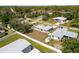 Aerial view of a fenced in backyard with a shed, surrounded by lush greenery and neighboring homes at 3886 Cincinnati St, North Port, FL 34286