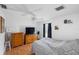 Bright bedroom featuring a ceiling fan, wood floors, and large windows with ample natural light at 3886 Cincinnati St, North Port, FL 34286