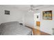 Well lit bedroom with wood floors, ceiling fan and ensuite bathroom access at 3886 Cincinnati St, North Port, FL 34286