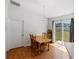 Bright dining room features wood floors, a dining table with chairs, and sliding doors to the backyard at 3886 Cincinnati St, North Port, FL 34286