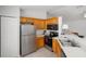 Functional kitchen with stainless steel appliances, light wood cabinets, and a breakfast bar for casual dining at 3886 Cincinnati St, North Port, FL 34286