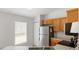 Efficient kitchen featuring stainless steel appliances, wooden cabinetry, and ample counter space for meal preparation at 3886 Cincinnati St, North Port, FL 34286