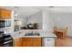 An open-concept kitchen featuring a breakfast bar that connects to the dining area at 3886 Cincinnati St, North Port, FL 34286