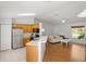 An open-concept living space adjacent to a functional kitchen with modern appliances, great for entertaining guests at 3886 Cincinnati St, North Port, FL 34286