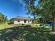 Fenced backyard with a fire pit, lawn, and swing set at 4092 Troost St, North Port, FL 34288