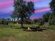 Spacious backyard with a fire pit and seating, perfect for outdoor gatherings at 4092 Troost St, North Port, FL 34288