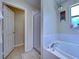 Cozy bathroom featuring a tub with a shower and tiled flooring at 4092 Troost St, North Port, FL 34288