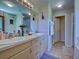 Bathroom with double sinks, ample storage, and tile flooring at 4092 Troost St, North Port, FL 34288