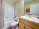Bathroom with a bathtub and shower combination, tiled walls, and vanity at 4092 Troost St, North Port, FL 34288