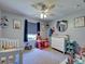 A bedroom is arranged with playful decor, a ceiling fan, a window, and themed decorations at 4092 Troost St, North Port, FL 34288