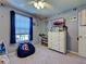 This cozy bedroom features a themed wall decorations, a window, and a ceiling fan at 4092 Troost St, North Port, FL 34288