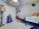 This bedroom includes Star Wars decor, bed, white closet, ceiling fan and carpeting at 4092 Troost St, North Port, FL 34288