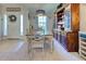 Elegant dining room with a wooden table, rustic hutch, and natural lighting at 4092 Troost St, North Port, FL 34288