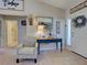 Inviting foyer with stylish decor, patterned chair, and a view into other rooms at 4092 Troost St, North Port, FL 34288
