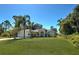 Charming single-story home with a well-maintained lawn and mature landscaping at 4092 Troost St, North Port, FL 34288