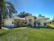 Beautiful one-story home featuring a well-kept lawn, mature landscaping, and attached garage at 4092 Troost St, North Port, FL 34288