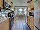 Well-lit kitchen featuring stainless steel appliances and an adjacent dining area with a sunny window nook at 4092 Troost St, North Port, FL 34288