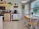 Cozy kitchen showcasing a charming coffee bar and breakfast nook with natural light and comfortable seating at 4092 Troost St, North Port, FL 34288