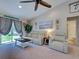 Comfortable living room features a ceiling fan, stylish furniture, and natural light at 4092 Troost St, North Port, FL 34288