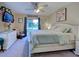 Serene main bedroom featuring a comfortable king-size bed, soft decor, and an adjacent sliding glass door at 4092 Troost St, North Port, FL 34288