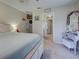 Cozy main bedroom with view to ensuite bath, vanity and king bed, promoting a relaxing atmosphere at 4092 Troost St, North Port, FL 34288
