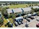 Aerial view of condo building near golf course and lake, ample parking and storage at 410 Cerromar S Cir # 240, Venice, FL 34293