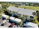 Aerial view showcasing a condo community with a golf course and pond nearby at 410 Cerromar S Cir # 240, Venice, FL 34293
