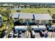 Overhead view of condos near a golf course and pond, with parking and well-kept landscaping at 410 Cerromar S Cir # 240, Venice, FL 34293