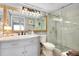 Updated bathroom features a glass-enclosed shower, modern vanity, and good lighting at 410 Cerromar S Cir # 240, Venice, FL 34293