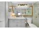 Charming bathroom with updated vanity, mirror and lighting fixtures at 410 Cerromar S Cir # 240, Venice, FL 34293