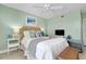 Comfortable bedroom featuring a ceiling fan and soft, pastel colors at 410 Cerromar S Cir # 240, Venice, FL 34293