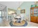 Dining area and view of open concept kitchen with breakfast bar and seating at 410 Cerromar S Cir # 240, Venice, FL 34293