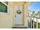 Close-up of a welcoming front door with a decorative wreath and secure entry features at 410 Cerromar S Cir # 240, Venice, FL 34293