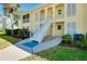 Charming two-story condo building with white shutters, a white staircase, and well-maintained landscaping at 410 Cerromar S Cir # 240, Venice, FL 34293