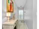 Entry hallway featuring light gray walls, accent table, and decor at 410 Cerromar S Cir # 240, Venice, FL 34293
