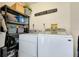 Functional laundry room with shelving and efficient washer and dryer units at 410 Cerromar S Cir # 240, Venice, FL 34293
