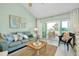 Inviting living room with balcony access, comfortable seating and coastal decor at 410 Cerromar S Cir # 240, Venice, FL 34293
