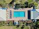 Aerial view of a rectangular pool with lounge chairs and well-maintained landscaping in a private community at 410 Cerromar S Cir # 240, Venice, FL 34293