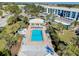 Aerial view of the community pool, surrounded by palm trees and lounge chairs at 410 Cerromar S Cir # 240, Venice, FL 34293