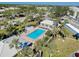 Aerial view showcases the community pool, surrounded by lush landscaping and palm trees, offering a relaxing resort-style experience at 410 Cerromar S Cir # 240, Venice, FL 34293