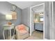 Cozy sitting room with chair and lamp, leading to the bathroom and closet at 410 Cerromar S Cir # 240, Venice, FL 34293