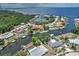 Aerial view of waterfront home with dock and backyard pool, situated on a canal at 4409 Crews Ct, Port Charlotte, FL 33952